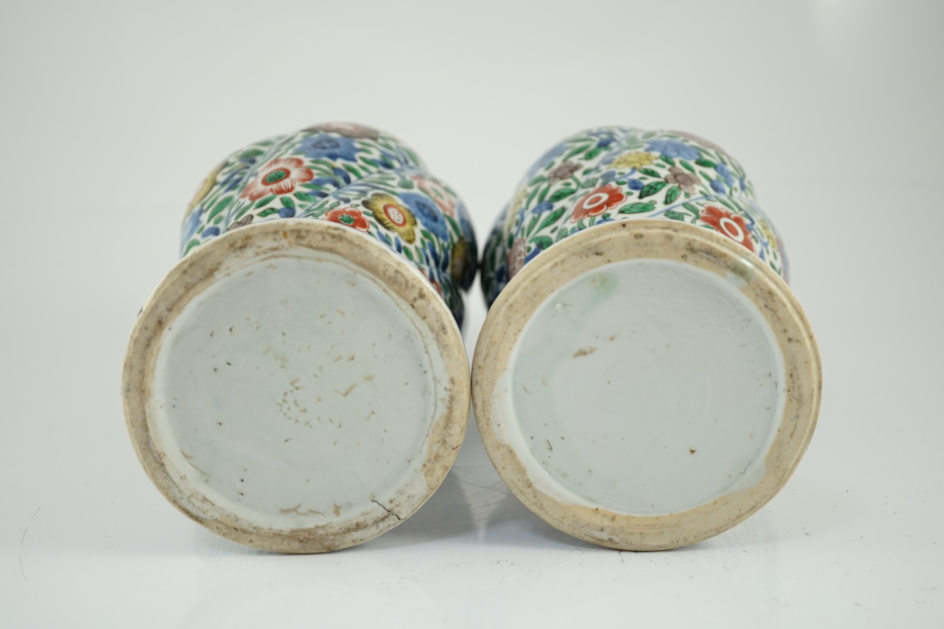 A pair of Chinese wucai spiral lobed baluster vases and covers, Kangxi, c.1680